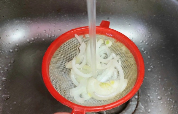 Промойте лук горячей водой.